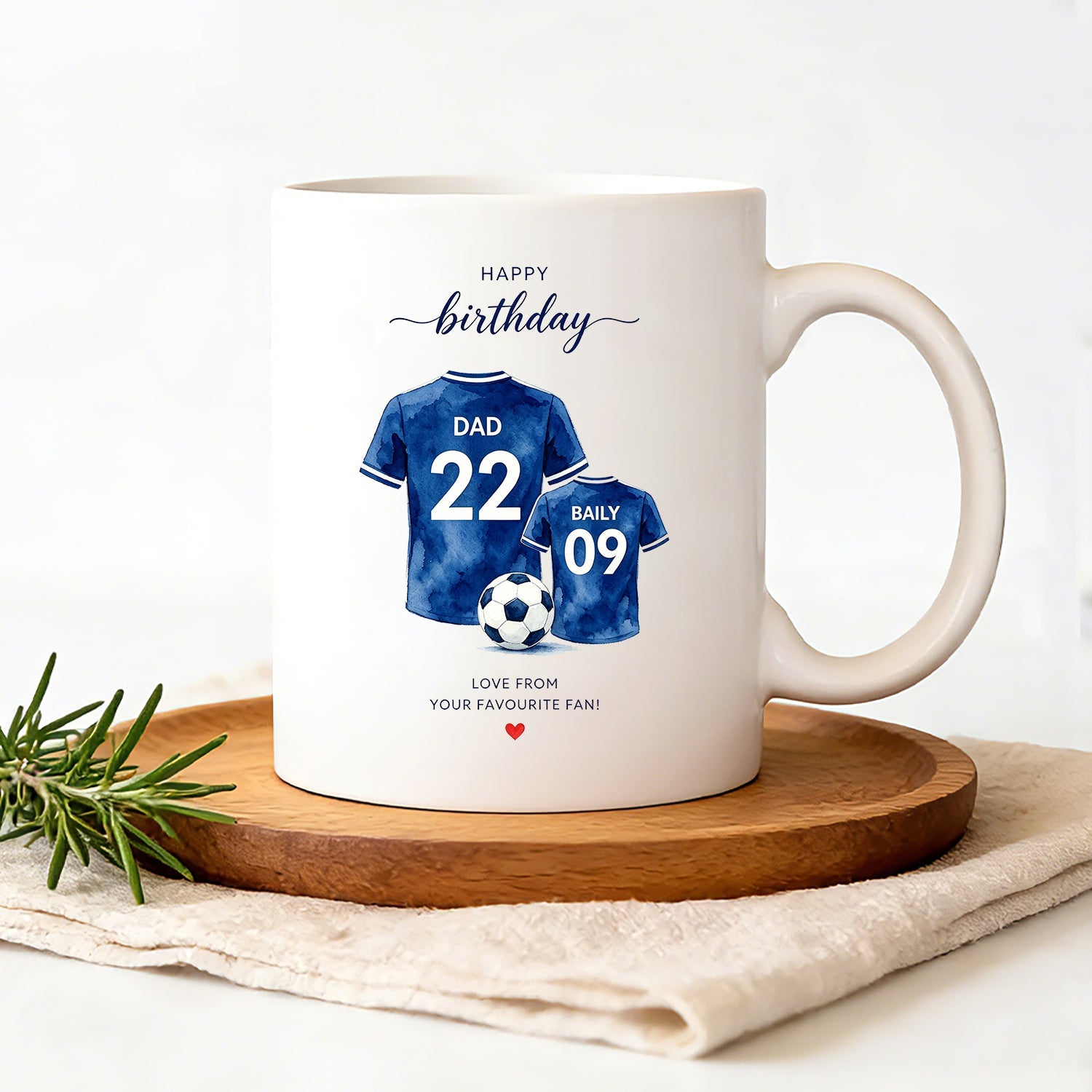 This 11oz ceramic mug features watercolor-style football jerseys, customizable with any name and number. Dishwasher and microwave safe.