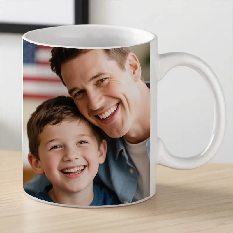 Custom Mug 12oz Photo Gift for Father's Day PrintToucan - A dad and his son, with the American flag in the background, share a warm smile on the mug.